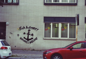 Graffiti, Text um einen Anker: Fuck Austerity, Refugees welcome